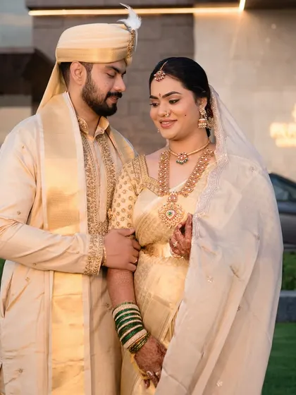 A classic Telugu bride, Nishitha, with her partner. Her makeup is timeless, with a focus on the sacred Pelli bottu and radiant skin.