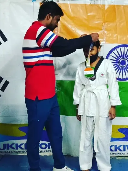 Placing the medal on another deserving champion.