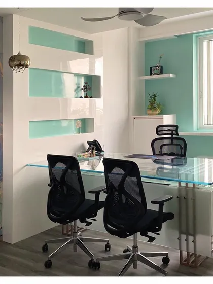 This image highlights the clean lines and reflective surfaces used in this cabin design. The combination of glass, high-gloss laminate, and a pop of color creates a modern and airy feel.