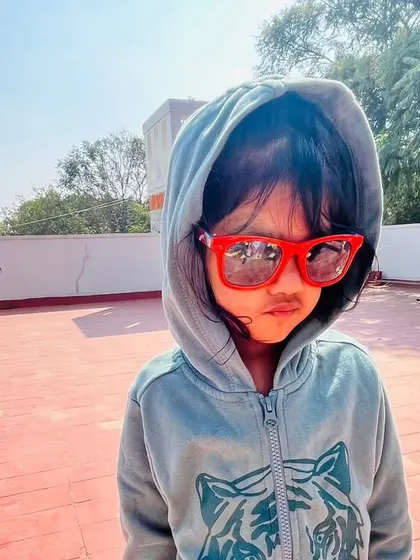 A child strikes a cool pose in a hoodie and sunglasses during our "winter sun" day on the terrace.