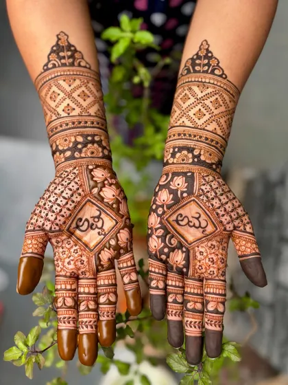 A full view of the baby shower mehendi with Kannada script, set against a natural green background.