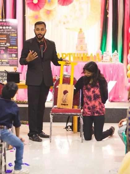 Here, a young volunteer is inspecting one of my props before the trick begins. I always let the audience check everything to show there are no strings attached, literally.