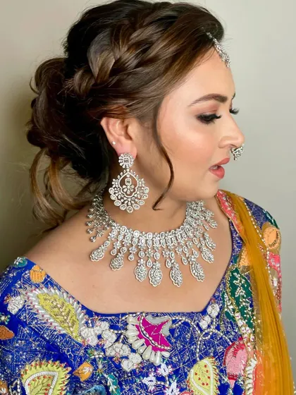 A close-up of the intricate hairstyle and makeup for the baraat.