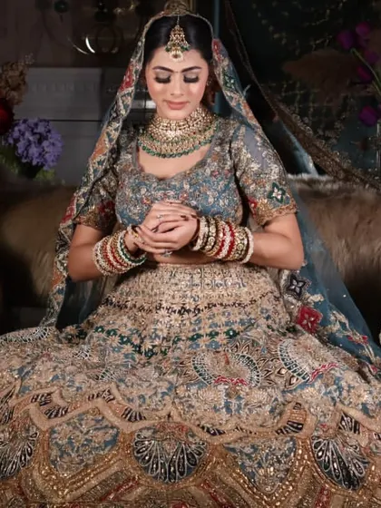 A serene bridal portrait showing the complete look. The makeup is flawless, and the pose is elegant, demonstrating the final result of my work.