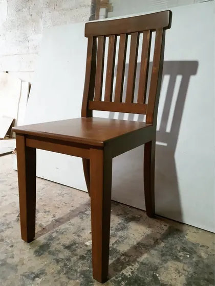 A classic dining chair with a slatted back, crafted from solid wood in our workshop.
