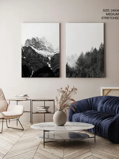 A breathtaking set of two black and white mountain photographs. The foggy, atmospheric scenes, presented as stretched canvases, bring the serene majesty of the Nordic landscape into your home.