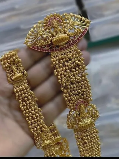 A close-up of a beautiful guttapusalu-style jade. The dangling pearls and temple motifs will look stunning woven into a bride's hair.