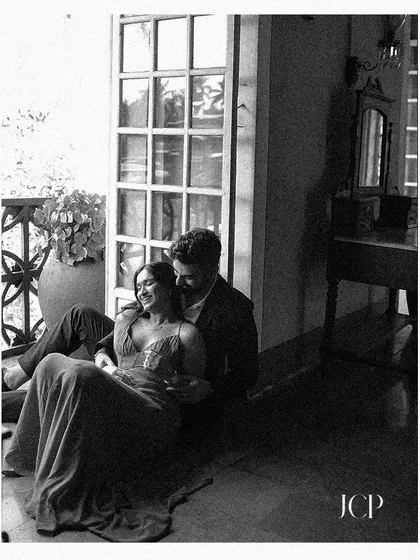 A moody black and white portrait, capturing a quiet and intimate pre-wedding moment.