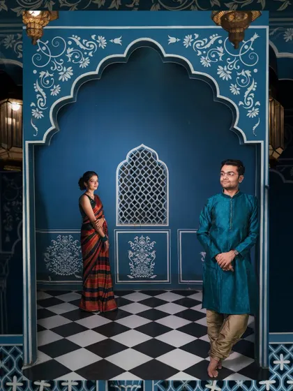 A beautifully composed shot from a styled indoor session with a royal blue, traditional Indian backdrop. This image showcases our ability to create regal and artistic portraits in a studio-like environment.