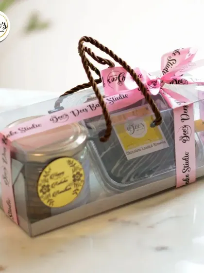 A clear view of a popular Rakhi hamper combination. This set includes a jar of cookies and a box of Chocolate Lined Brownies, presented in a convenient carry bag.