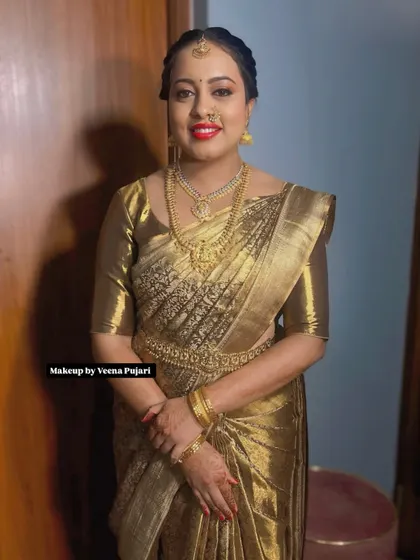 A full portrait of Priyanka at her son's naming ceremony. The all-gold look is regal and celebratory, perfect for a new mother.