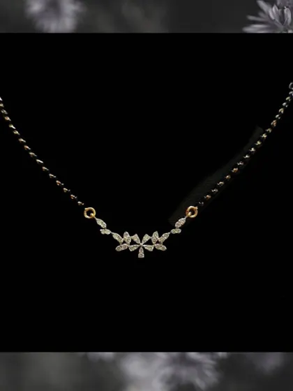 A very delicate design for daily wear. This mangalsutra features a small cluster of marquise-cut diamonds, offering a subtle sparkle that is perfect for everyday elegance.