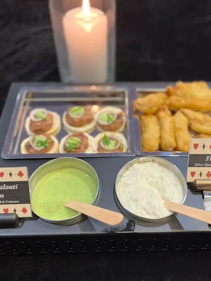 This platter offers a taste of both land and sea with our Mutton Galouti Kebabs and Fish Orley. Served with mint and tartar sauces, it caters to diverse palates at any event.