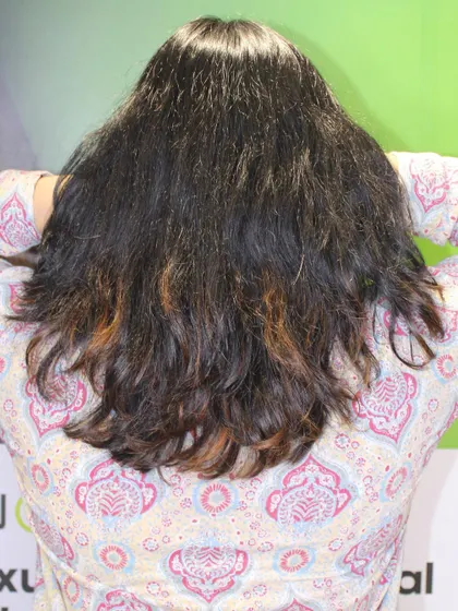 The "before" shot, showing dark, frizzy hair ready for a wonder blonde transformation.