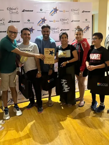 The entire winning team receiving their award at the Rotary Club badminton tournament.