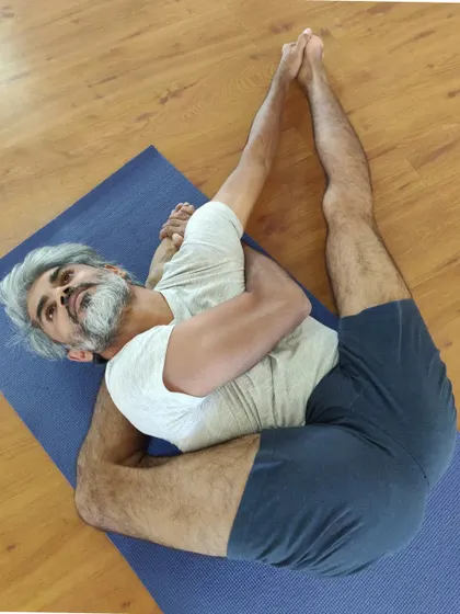 Exploring a creative variation on my mat. This pose combines elements of a deep hip opener with a supine twist, showing that practice can be a space for discovery and play.