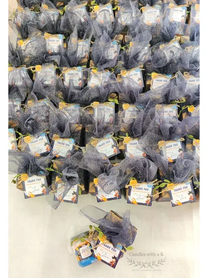 The entire set of 65 space-themed birthday favors, wrapped in sparkly blue net.
