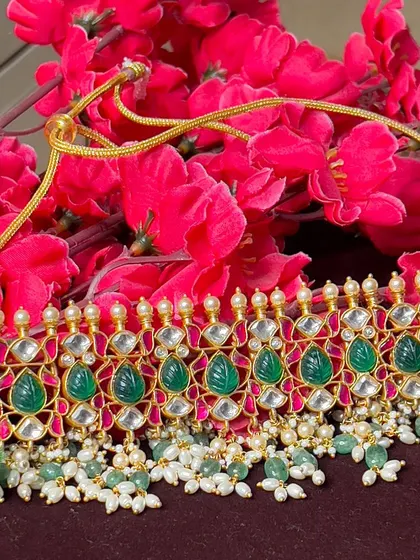 Another view of the beautiful green Kundan choker. The combination of uncut stones and pearls creates a look of understated luxury.
