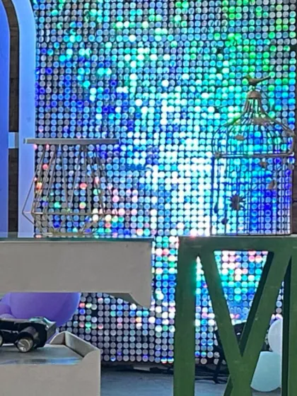 A close-up of a blue and green shimmer wall, adding a touch of sparkle and glamour to the event decor.