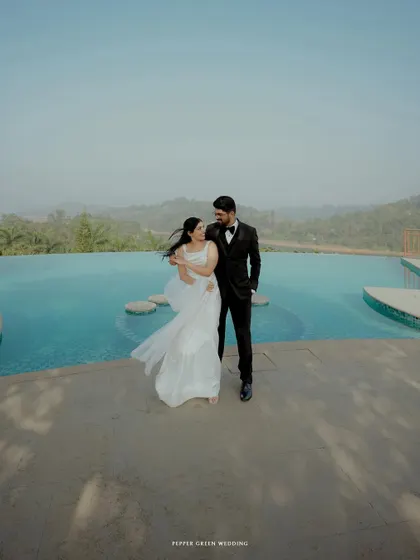A modern and romantic portrait by an infinity pool, the vastness of the water and sky adding to the epic feel of their wedding day.