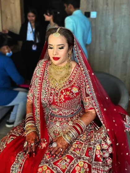 Another shot of this classic red bride. The makeup is designed to be photogenic from all angles, ensuring she looks perfect in every memory.