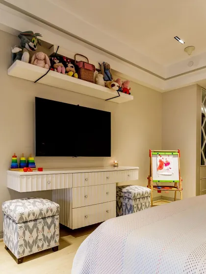 This floating dresser and media unit is a great space-saving solution. It provides drawer storage and a surface for a TV or toys, while the ottomans can be tucked underneath when not in use.