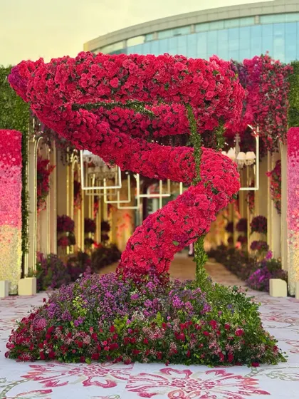 Another angle of the dramatic red floral sculpture, showing how it commands attention and creates a central point of interest in the large outdoor space.