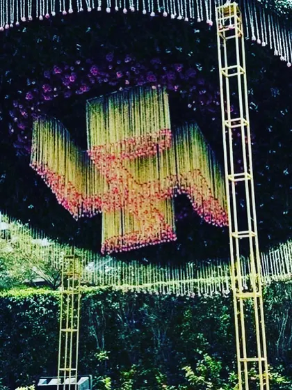 A detailed shot of the hanging floral installation from the circular canopy. This shows the intricate work involved in creating such a large-scale, custom floral feature for a grand wedding.
