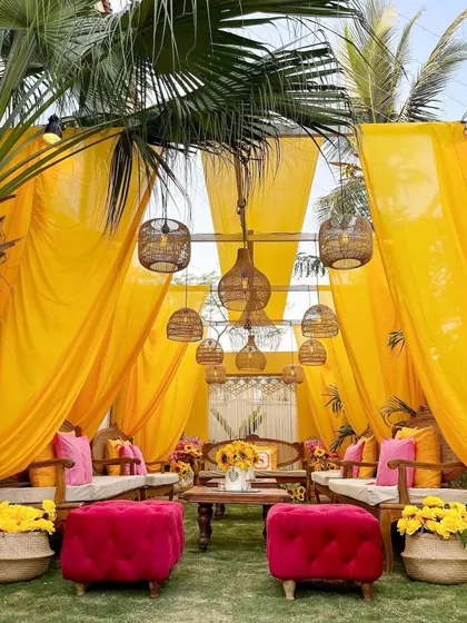 Even intimate gatherings can make a grand statement. This vibrant Haldi or Roka setup is filled with the cheerful warmth of sunflowers, bright yellow drapes, and pops of pink, creating a joyful and picturesque setting.