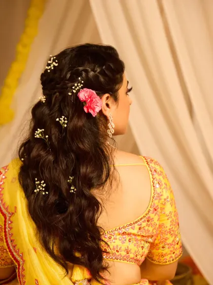 Another angle of the half-updo, showing the beautiful braid and the placement of the flowers. It's a perfect look for a daytime event.