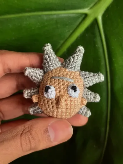 A close-up of the Rick Sanchez amigurumi. Capturing his wild hair and perpetually unimpressed expression was the best part of this custom character project.