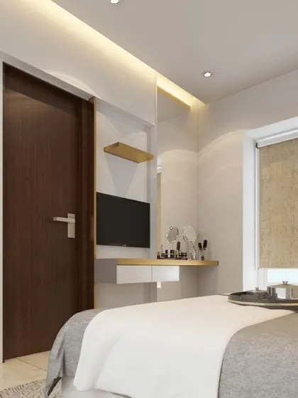 A simple and functional bedroom with a compact TV and vanity unit, showcasing smart design for smaller spaces.