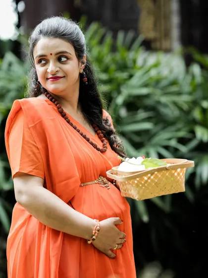 A beautiful three-quarter portrait of the expectant mother from our Ram and Seetha shoot. She holds a basket of flowers, adding a classic, graceful element to her character.