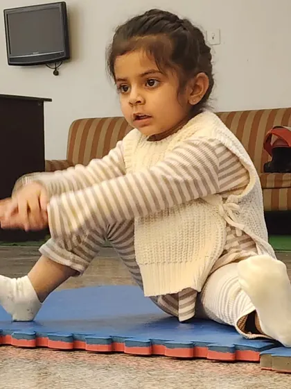 Look at that focus. A young student practices a seated pike stretch, learning body awareness and control. We ensure every child gets the attention they need to learn correctly and safely.