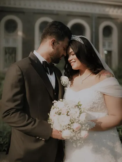 An intimate moment between the newly married couple, their foreheads touching in a gesture of love and connection.