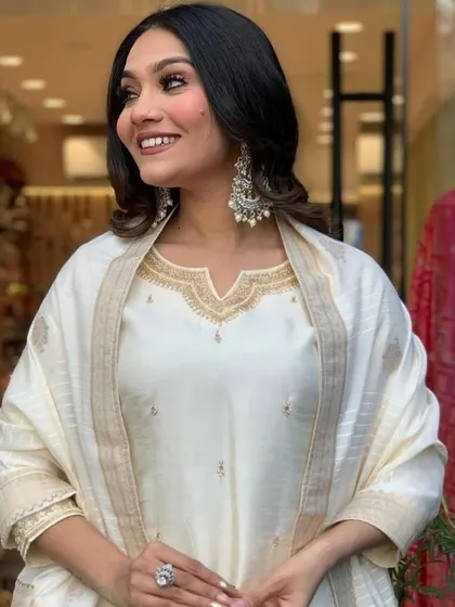 This cream viscose chanderi kurta set is pure elegance. The subtle gold detailing and classic silhouette make it perfect for a puja or family function.