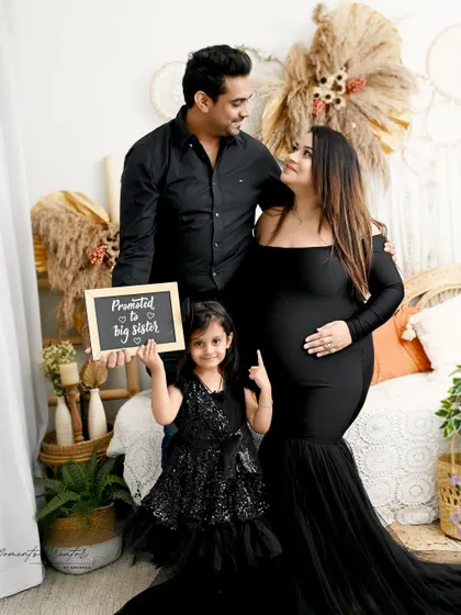 "Promoted to Big Sister!" This family portrait is a fun and heartwarming way to announce the new arrival, with the whole family dressed in coordinating black outfits in my boho-themed setup.