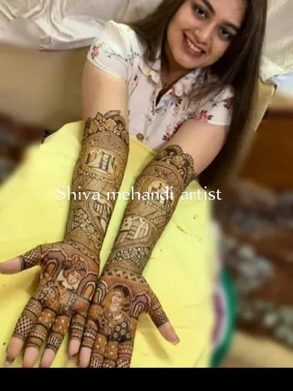 A happy bride showcasing her personalized mehendi, which includes portraits of her and her partner. The design captures their likeness and is surrounded by intricate wedding story elements.