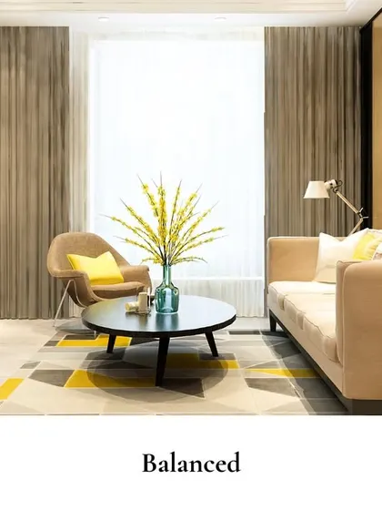 A balanced living room design where a marble-clad fireplace and a geometric rug are complemented by pops of yellow in the cushions, creating a modern and comfortable space.