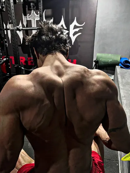 A different angle of the traps, showing how they connect to the shoulders and upper back, creating a powerful look.
