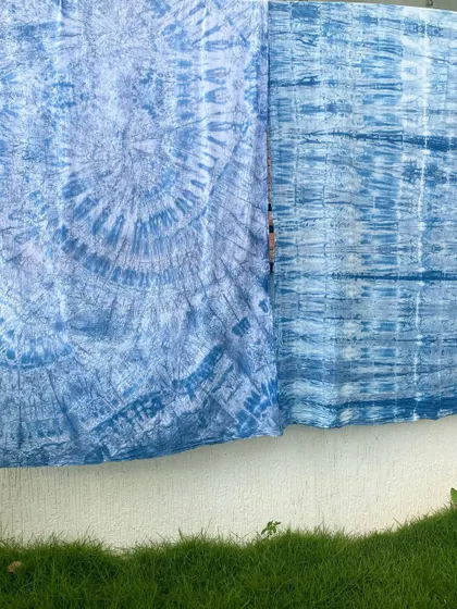 A beautiful display of fabrics hand-dyed with natural indigo. The different shades and patterns show the versatility and depth of this magical blue dye.