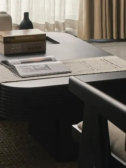 This custom black coffee table with fluted details serves as a bold centerpiece in the living room. Paired with a classic Chandigarh chair, it reflects my approach of mixing modern forms with timeless design elements.