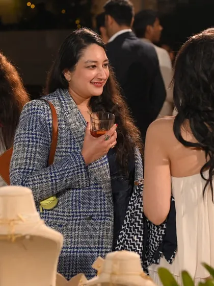 Guests exploring the newly launched 'Mehr' collection at our exclusive rooftop event, surrounded by elegant displays and engaging conversations.