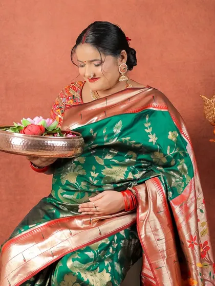 A beautiful composition featuring a mom-to-be in a traditional saree holding a decorative bowl of flowers, symbolizing life and beauty.