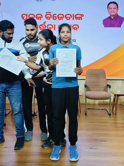 A young rugby player receives her certificate from the Odisha Government. These moments of recognition are crucial for validating the hard work of young athletes and motivating them to aim higher.
