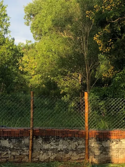 A completed gabion compound wall, built with layers of stone and brick held within a wire mesh. This technique is not only sturdy but also creates a beautiful, rustic aesthetic.