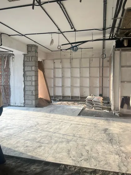 This behind-the-scenes shot from a site in Gurugram shows the structural framework for built-in shelving being installed. It's in these early stages that the foundational elements of a well-organized and functional space are established.