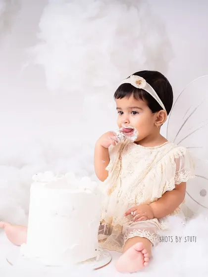 A wider view of the dreamy, cloud-like setup for this fairy-themed cake smash. I take care to create a beautiful and safe environment for your baby to explore and enjoy.