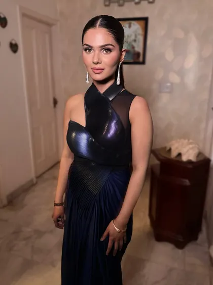 Another angle of the minimalist glam look. The iridescent fabric of the gown is the star, so the makeup is kept refined and elegant to create a balanced and modern style.