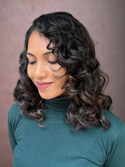 A curl and color transformation for Leona, featuring pintura highlights to define her curls.